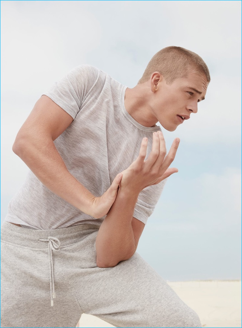 American model Mitchell Slaggert sports a grey t-shirt and pants from Calvin Klein Collection's pre-spring 2017 cashmere line.