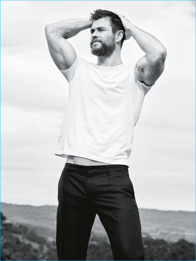 Actor Chris Hemsworth flexes his biceps for a GQ Australia photo shoot.