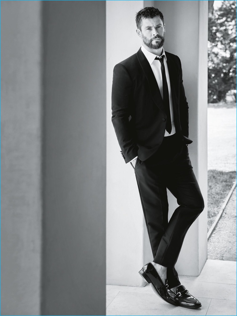 Brad Homes outfits Chris Hemsworth in a traditional black suit for GQ Australia.