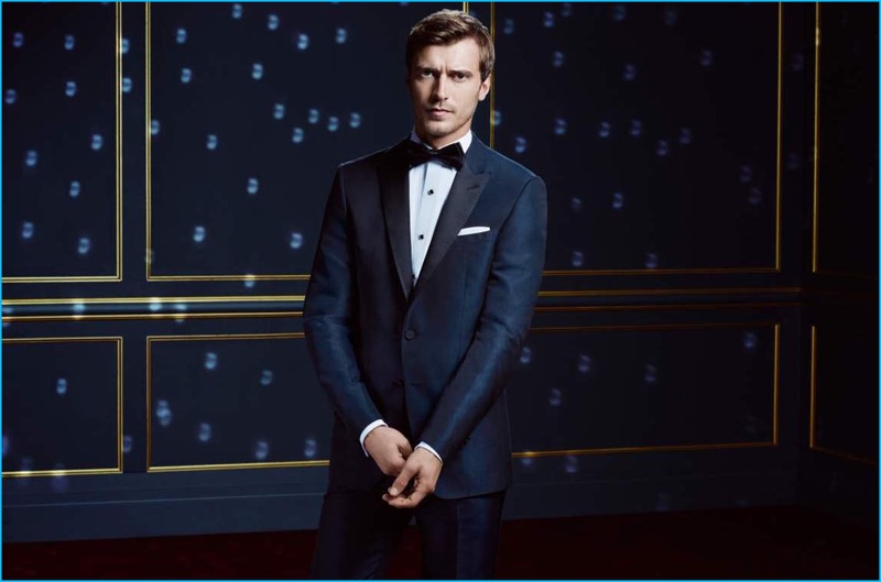 BOSS reunites with Clément Chabernaud for its holiday 2016 campaign. The French model sports a blue tuxedo for the occasion.