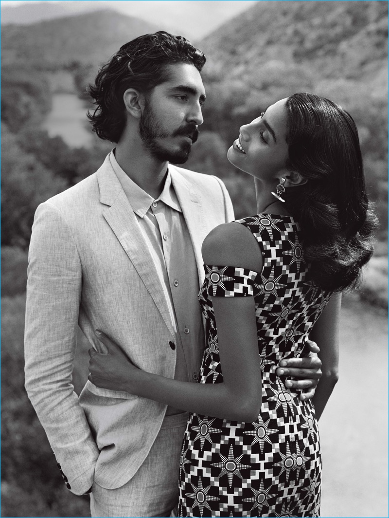 Imaan Hammam embraces Dev Patel, who wears a Burberry suit with an Agnes B shirt.