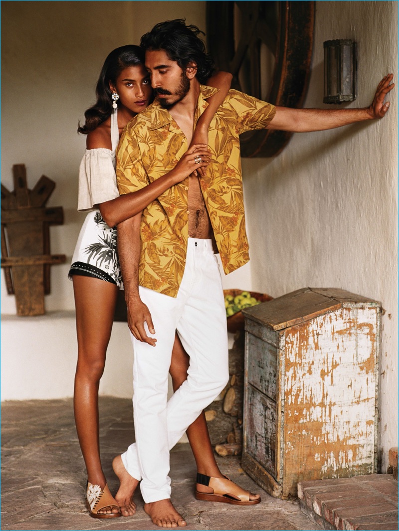 Appearing alongside Imaan Hammam, actor Dev Patel dons a patterned shirt by David Hart with white pants.