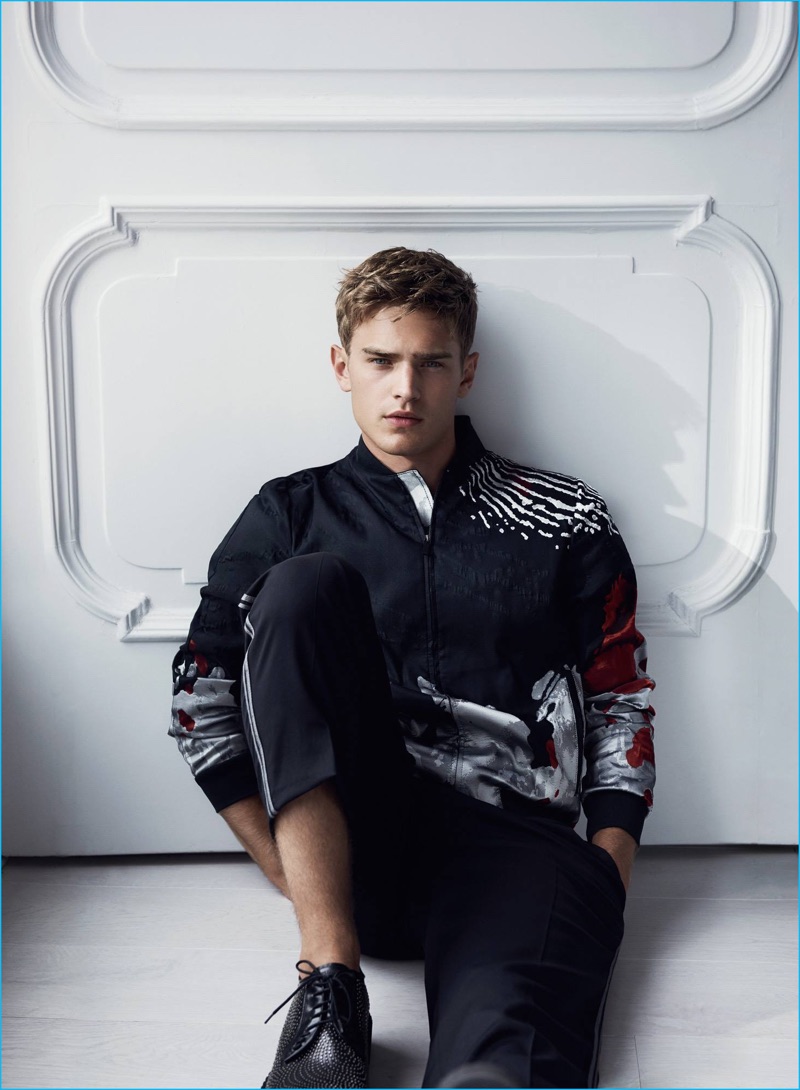 Bo Develius relaxes in a printed bomber jacket and virgin wool trousers for Emporio Armani's cruise 2017 campaign.