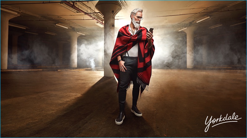 Checking his messages, Fashion Santa is chic in a Moncler red and black poncho scarf with a John Varvatos henley. Fashion Santa also rocks Trafalgar suspenders with Dsquared2 joggers, Balenciaga sneaker boots, and Paul Smith glasses.