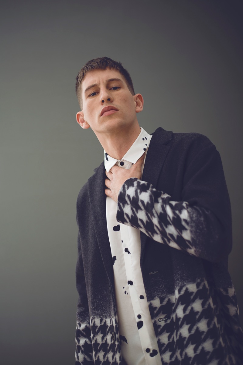 Jannik wears a houndstooth print Rogues of London coat with a patterned Topman shirt.