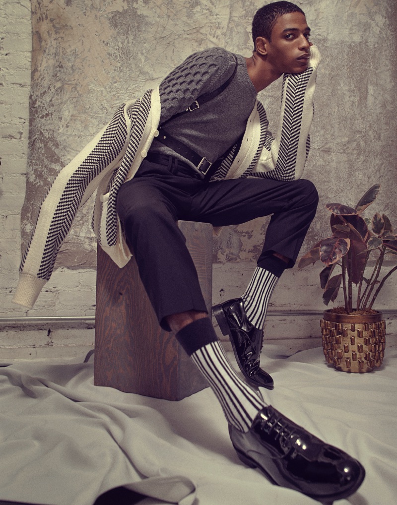 Darron wears sweater Zachary Prell, cardigan David Hart, trousers Tim Coppens, harness Zana Bayne, and shoes Florsheim.