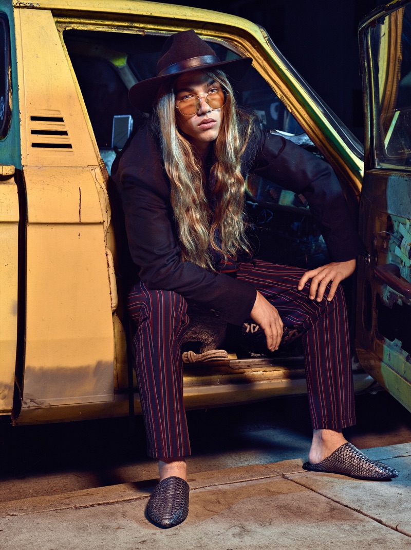 Daniel Hivner embraces a bohemian cool in a striped look from The Kooples with a Gladys Tamez Milinery hat, and RETROSUPERFUTURE sunglasses.