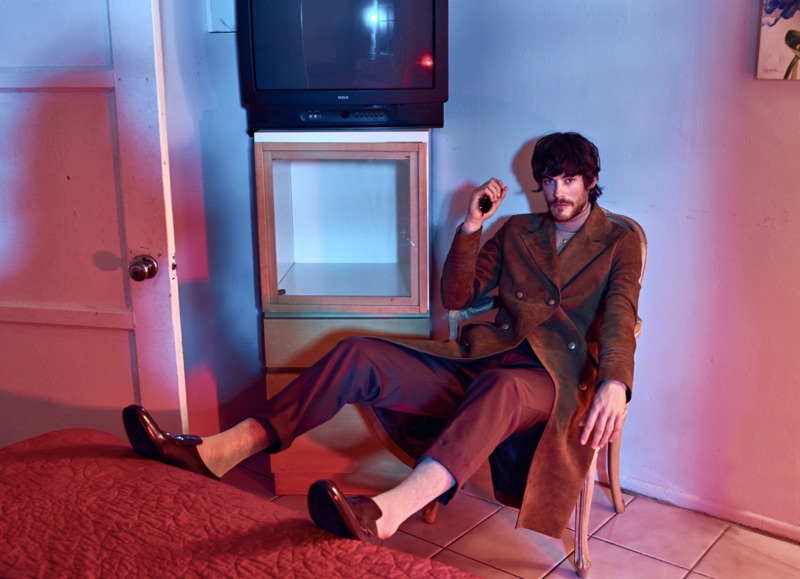 Jonas Kesseler makes a brown statement in Jeffrey Rüdes double-breasted coat with tailored pants and shoes. The German model also sports a Hugo Boss turtleneck.