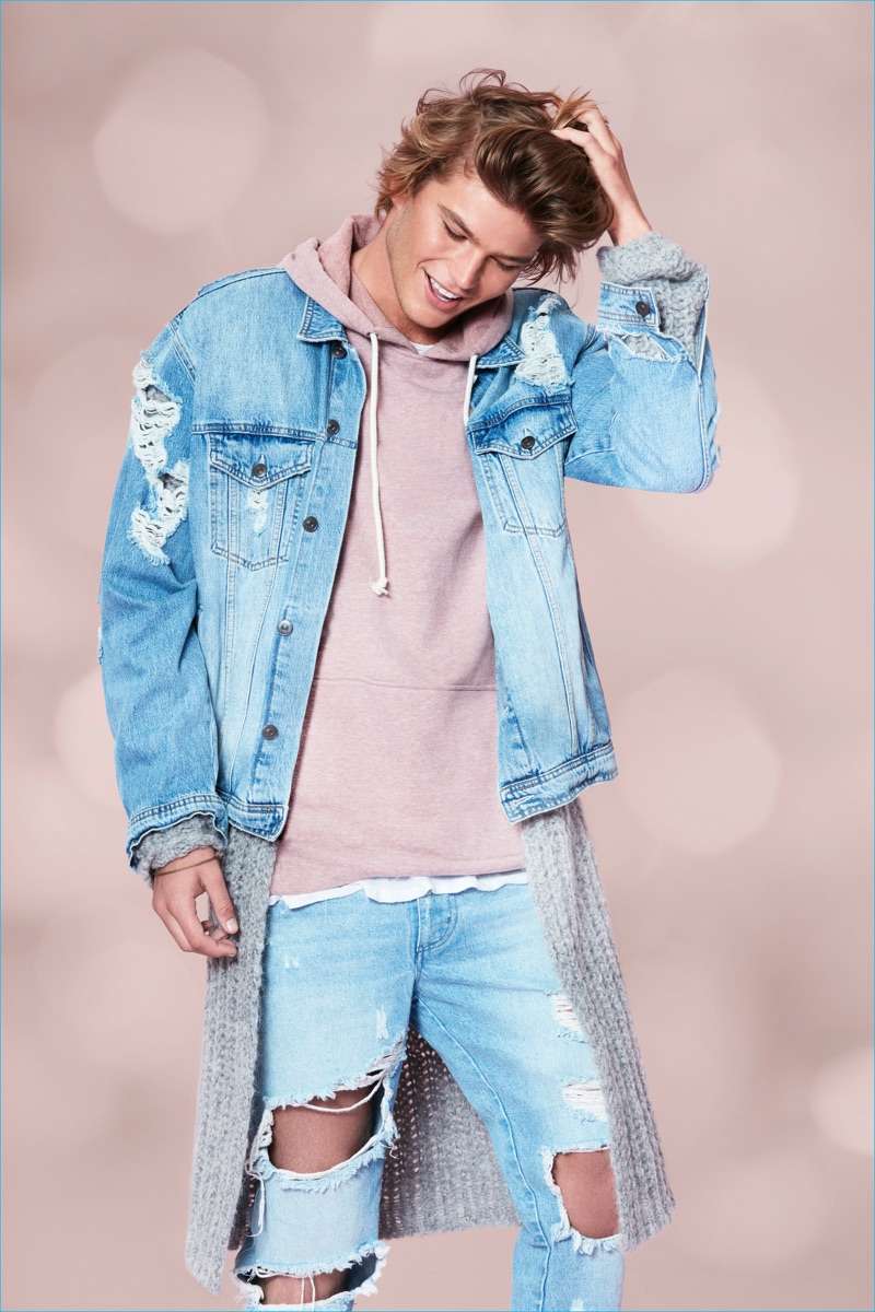 Jordan Barrett wears distressed denim for Forever 21's holiday 2016 campaign.