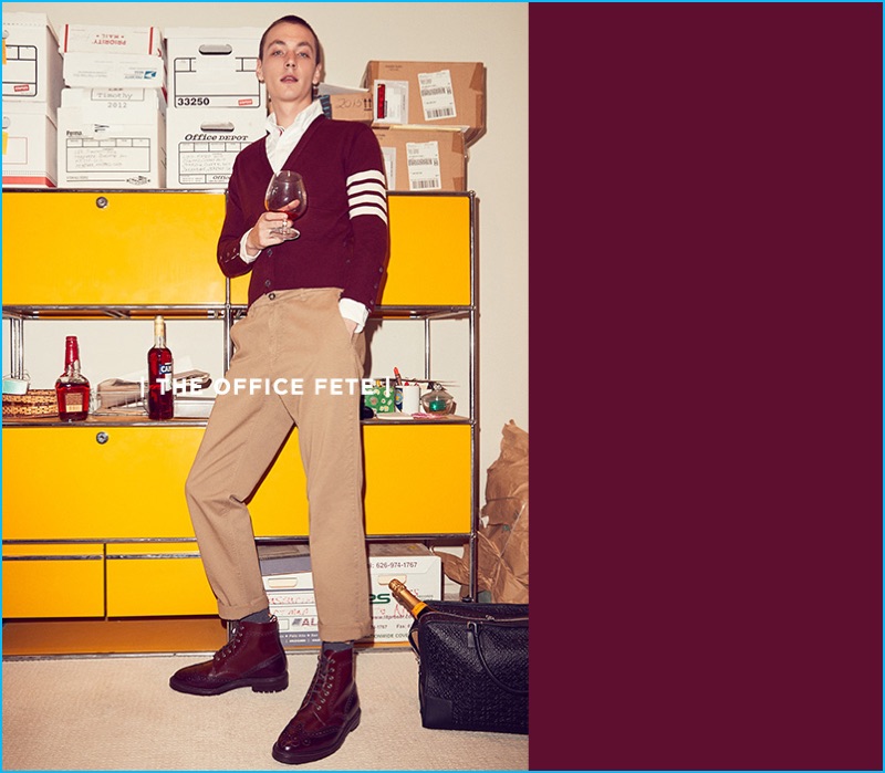 Ready for an office party, Yuri Pleskun models a Thom Browne shirt, burgundy cashmere cardigan, and leather wingtip boots with beige Kenzo trousers.