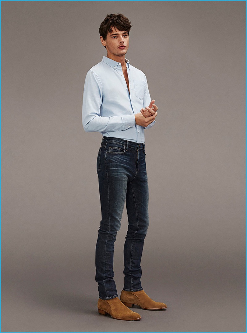 Frame Denim pairs its dark wash distressed denim with a smart shirt and trendy ankle boots.