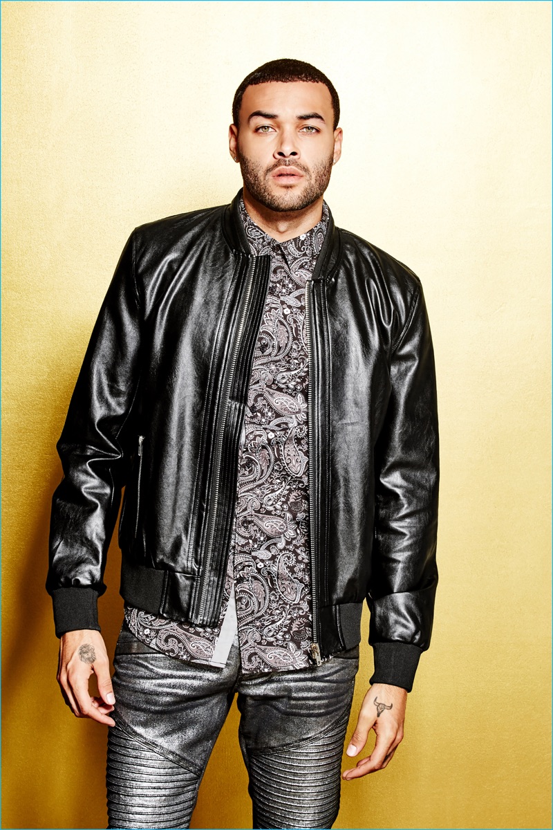 Front and center, Don Benjamin rocks a leather jacket with gold skinny moto jeans, and a paisley print shirt from G by GUESS' Empire collection.