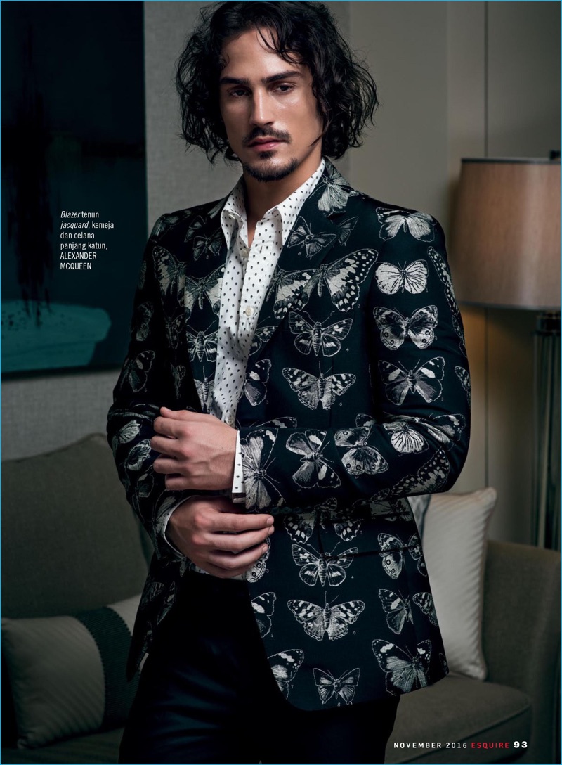 Playing a dandy, Gustavo Krier dons a butterfly print jacket with smart separates by Alexander McQueen.
