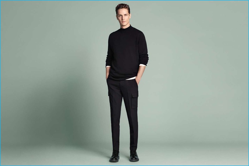 Peter Bruder is a sleek vision in a H&M mock turtleneck sweater, henley, wool-blend cargo pants, and derbies.