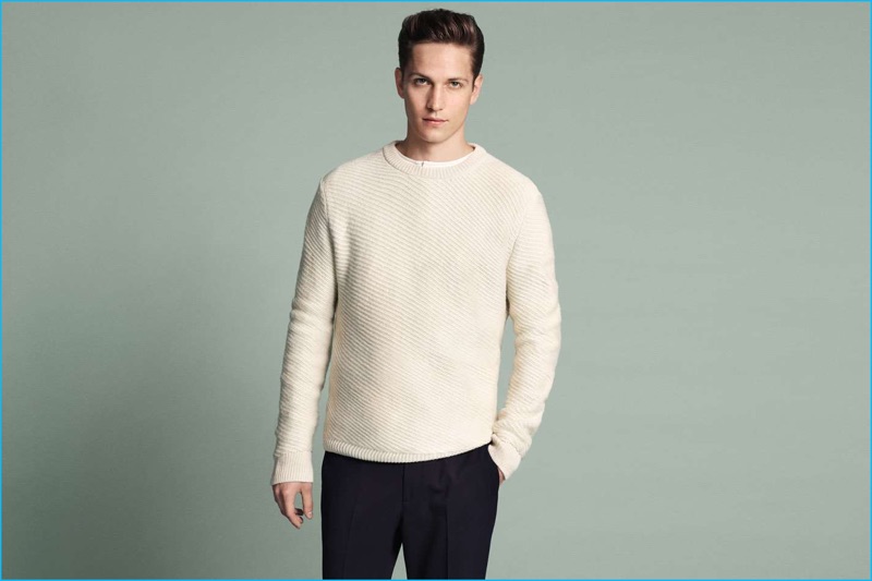 German model Peter Bruder wears a jersey, wool-blend sweater, and cropped trousers from H&M.