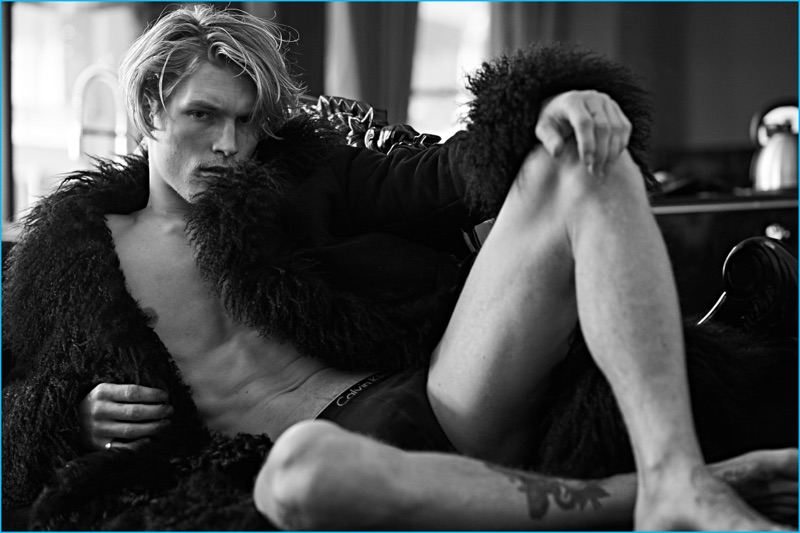 Lounging, Harry Goodwins rocks a Dolce & Gabbana coat with Calvin Klein underwear.