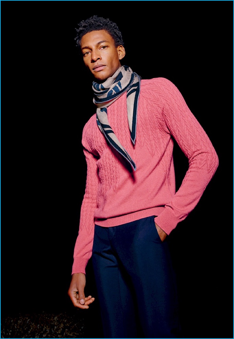 Ty Ogunkoya is a standout in a knit Hermès sweater, slim-cut trousers, and a patterned scarf.