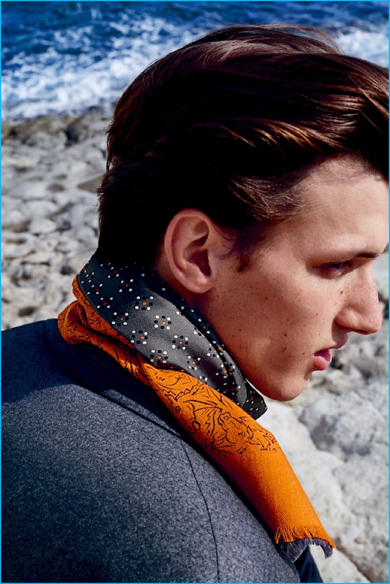 Delivering a side profile, Luca Stascheit wears a beautiful scarf from Hermès' fall-winter 2016 range.