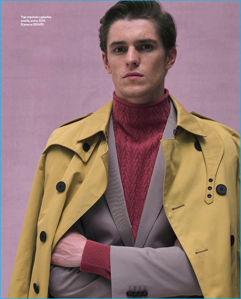 Adrien Dantou dons a grey suit and pale yellow trench coat from BOSS Hugo Boss. The French model also wears a turtleneck sweater from Hermes.