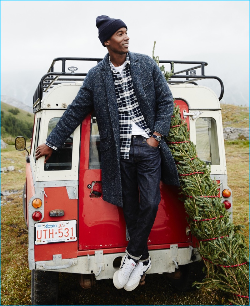 Claudio Monteiro dons an unconstructed Italian herringbone topcoat, Wallace & Barnes blue flannel plaid shirt, and a garment dyed t-shirt from J.Crew. Stepping out in style, Claudio also sports 770 raw selvedge denim jeans, a knit beanie, and Onitsuka Tiger GSM sneakers.