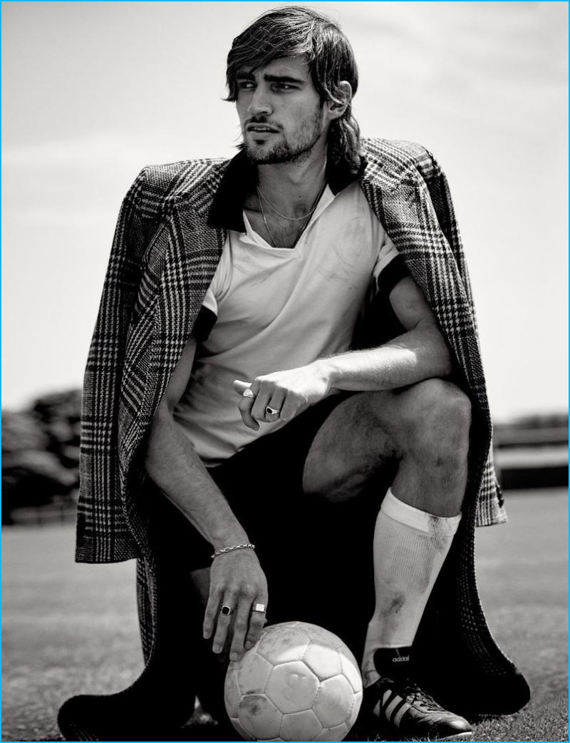 Australian model Jack Tyerman dons a HUGO double-breasted wool coat with a vintage football shirt and shorts from Carlo Manzi. Jack also sports Adidas shoes.