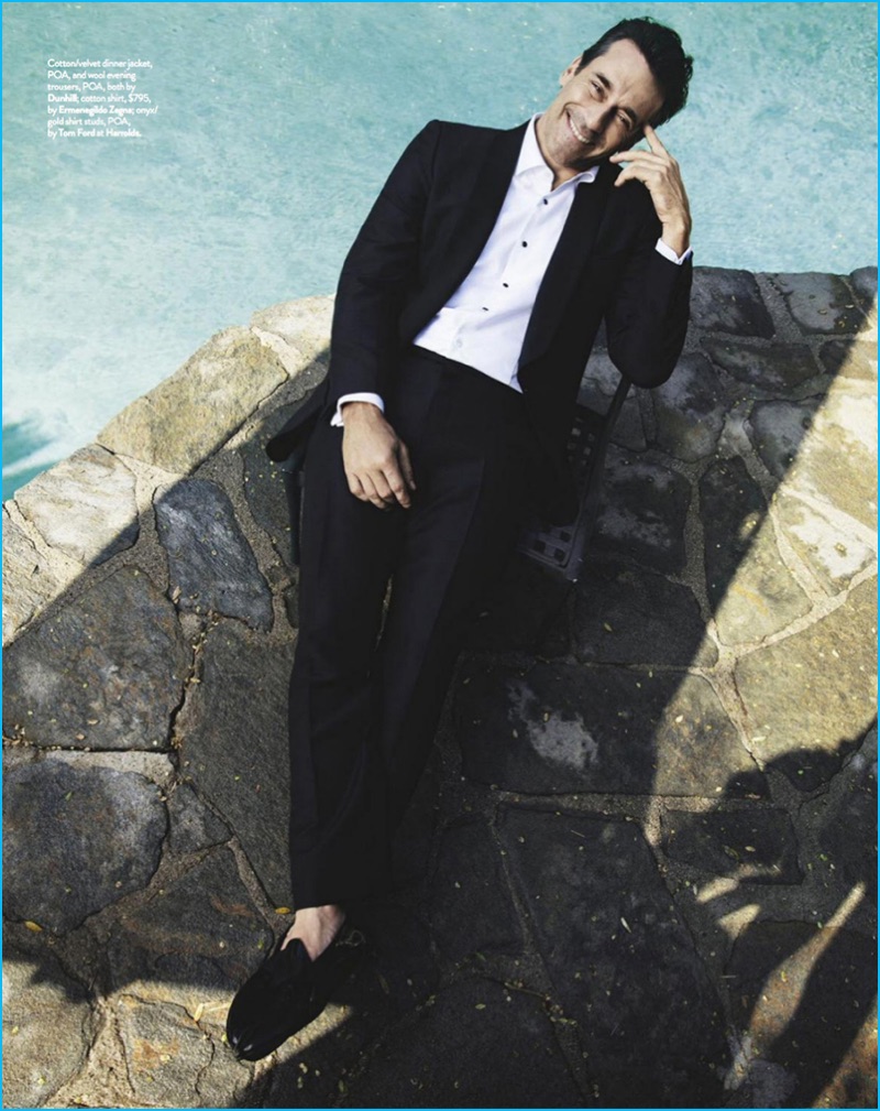 Relaxing poolside, Jon Hamm wears a dapper suit by Dunhill with an Ermenegildo Zegna shirt.