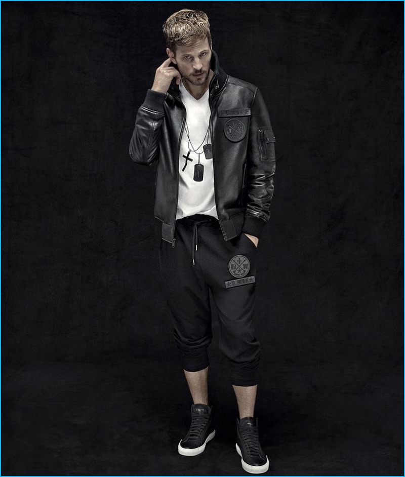 Model Kelly Rippy sports a lambskin leather bomber jacket, graphic t-shirt, and cropped sweatpants from Daniel Won.