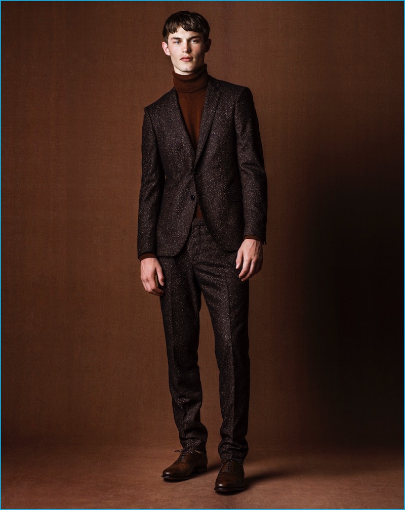 Standing tall, Kit Butler wears a suit and sweater by Hugo Boss with Crockett and Jones shoes.