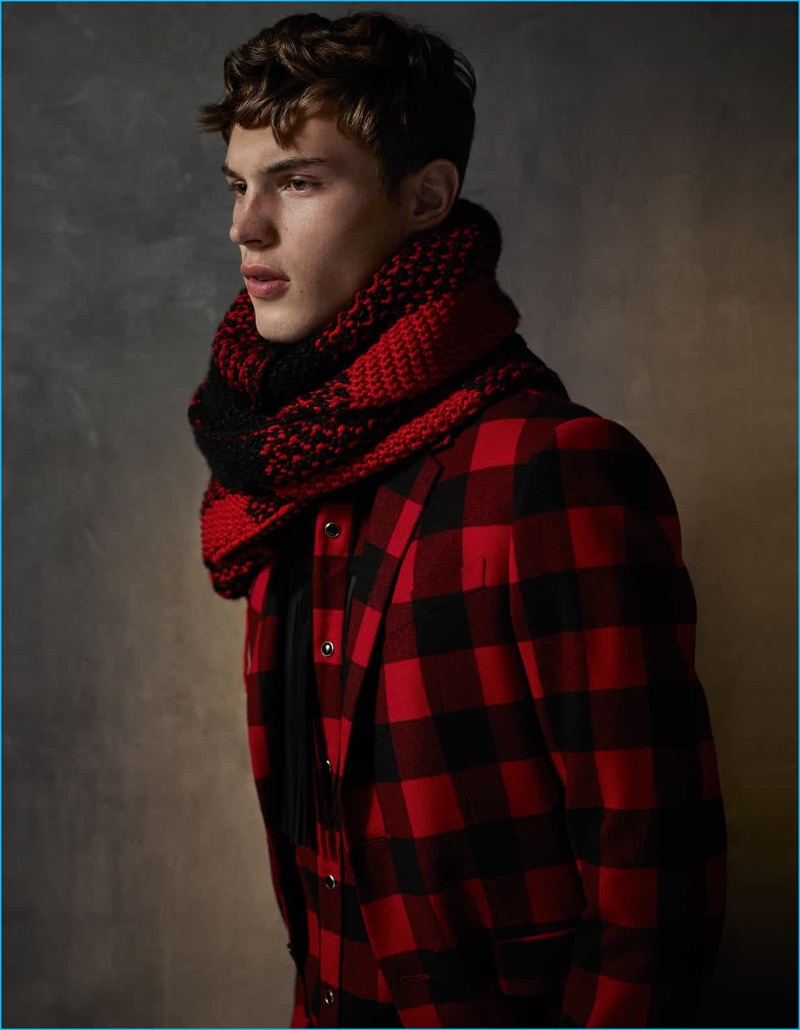 Damian Foxe photographs Kit Butler in a red and black buffalo check wool suit, shirt, and sweater, worn as scarf.