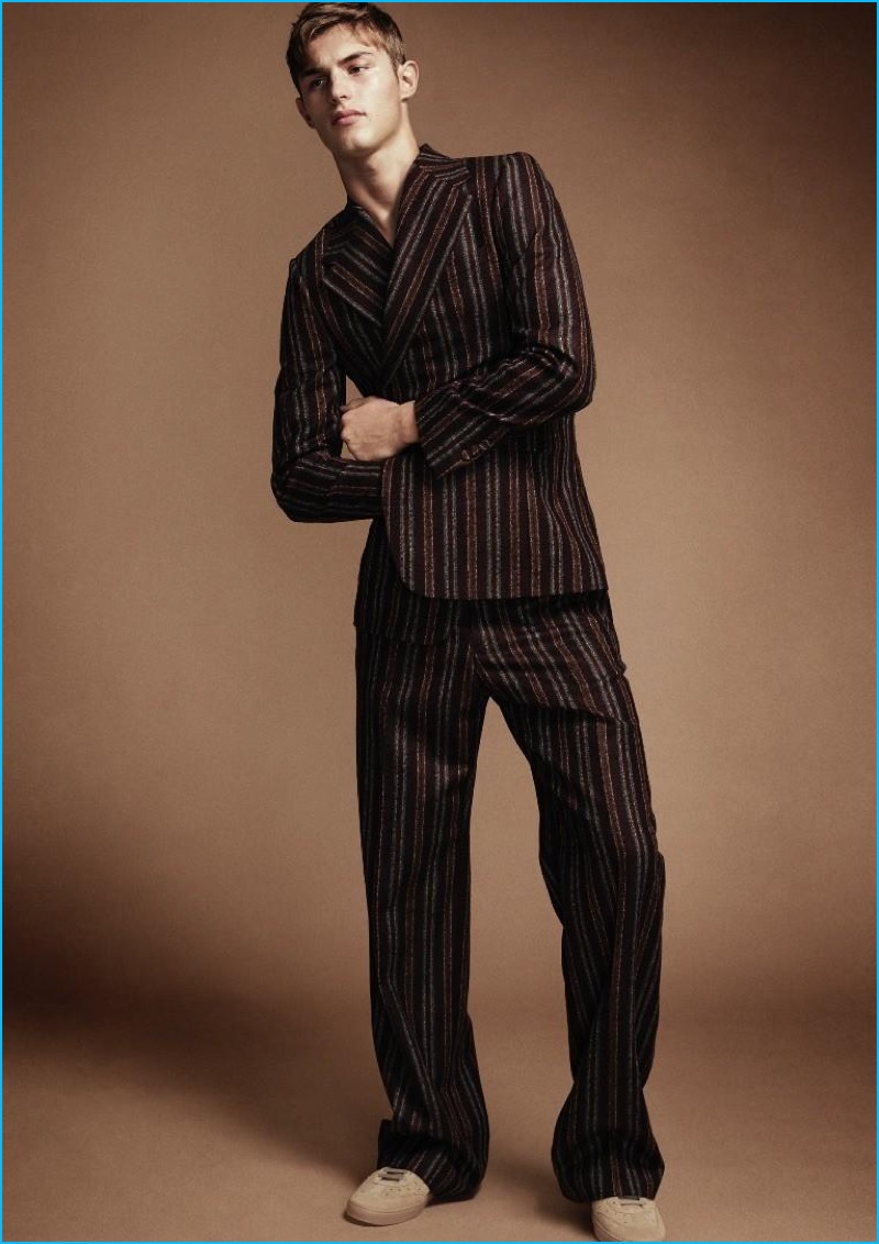 Model Kit Butler dons a striped Dries Van Noten wool suit.