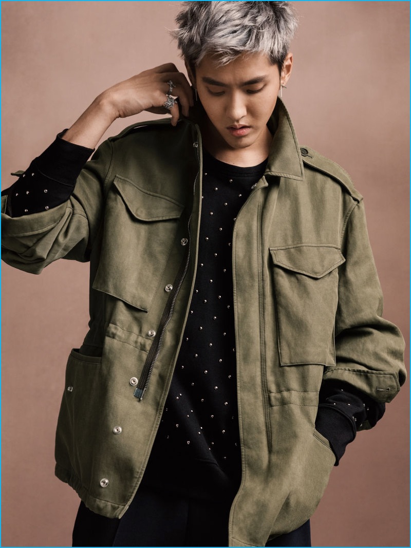 Going casual, Kris Wu wears a green field jacket, riveted sweatshirt, and sports-striped sweatpants by Burberry.