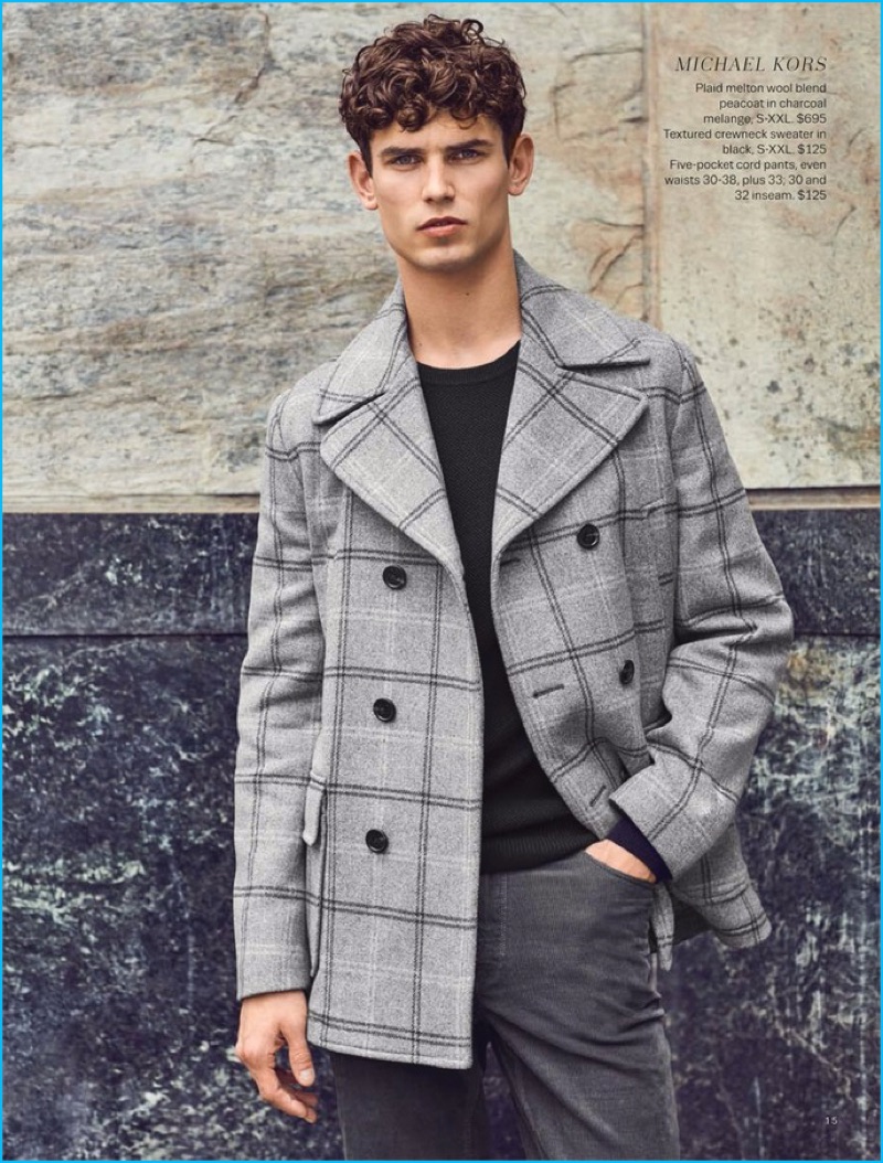 Model Arthur Gosse sports a plaid peacoat, sweater, and corduroy pants from Michael Kors.