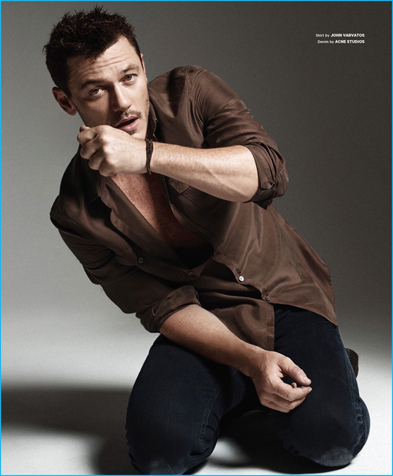 Actor Luke Evans wears a brown John Varvatos shirt and denim jeans from Acne Studios for Essential Homme.