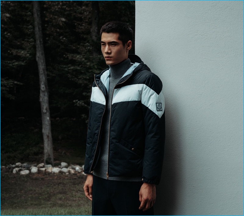 Front and center, Hao Yun Xiang sports a contrast stripe down jacket by Moncler Gamme Bleu with a turtleneck sweater from Raey. Hao also dons wool and cashmere-blend Gucci trousers.