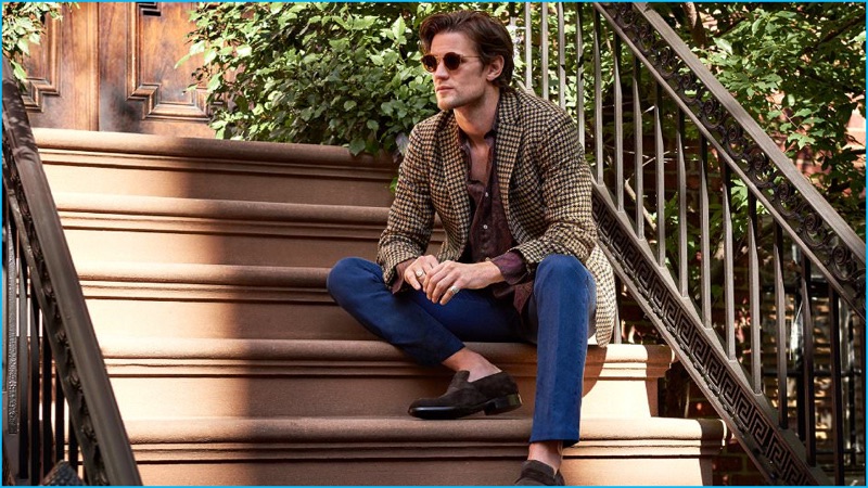 Matt Smith connects with Mr Porter, wearing an Incotex houndstooth blaze, an Our Legacy paisley flannel shirt, and Tom Ford denim trousers. Smith also sports Ermenegildo Zegna suede penny loafers with Thom Browne sunglasses.