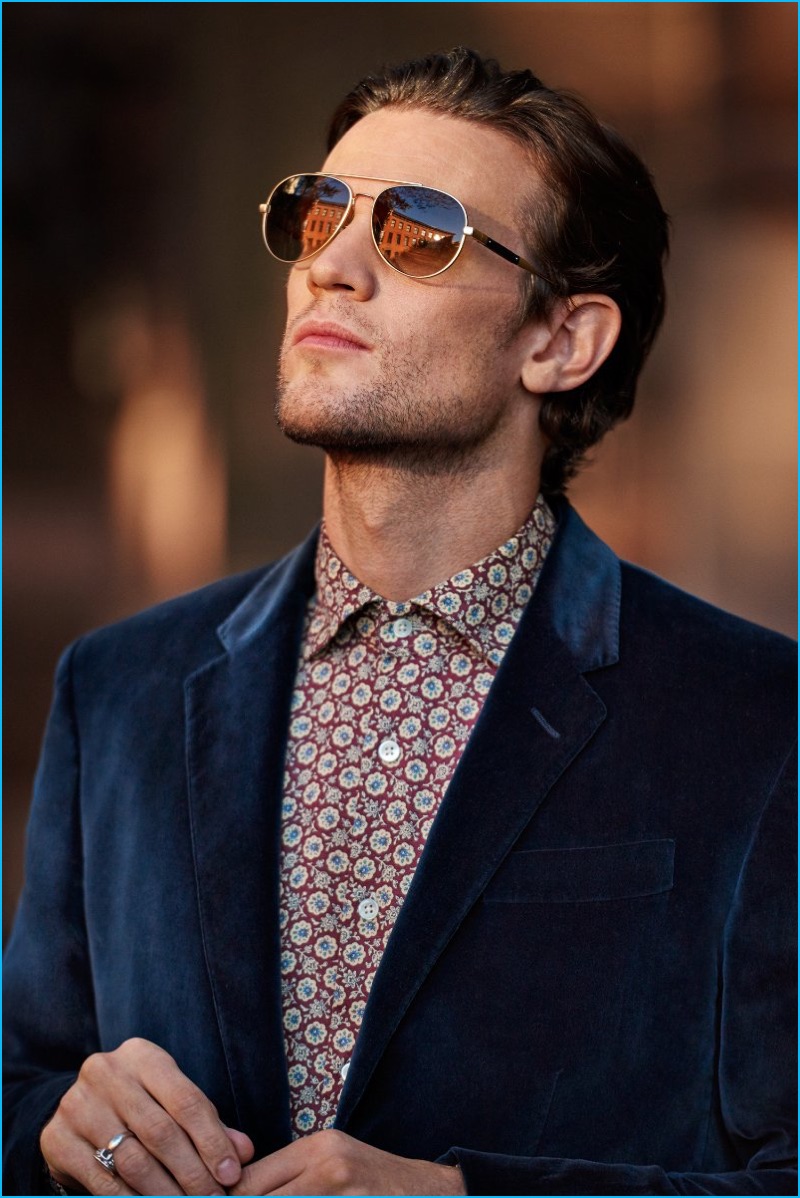 Actor Matt Smith rocks a Gucci velvet blazer with an Incotex print shirt, and Ray-Ban aviator sunglasses.