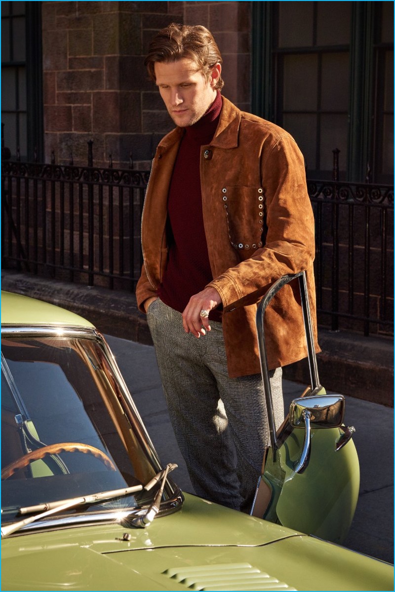 Julie Ragolia outfits Matt Smith in an Acne Studios suede jacket, Incotex turtleneck sweater, and Sandro suit trousers.