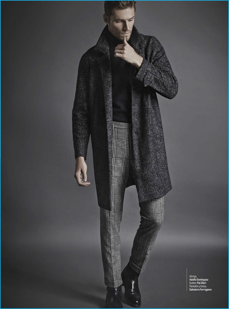 Latvian model Mikus Lasmanis wears an Adolfo Dominguez coat with a Pal Zileri sweater. The top model also sports trousers and leather boots by Salvatore Ferragamo.