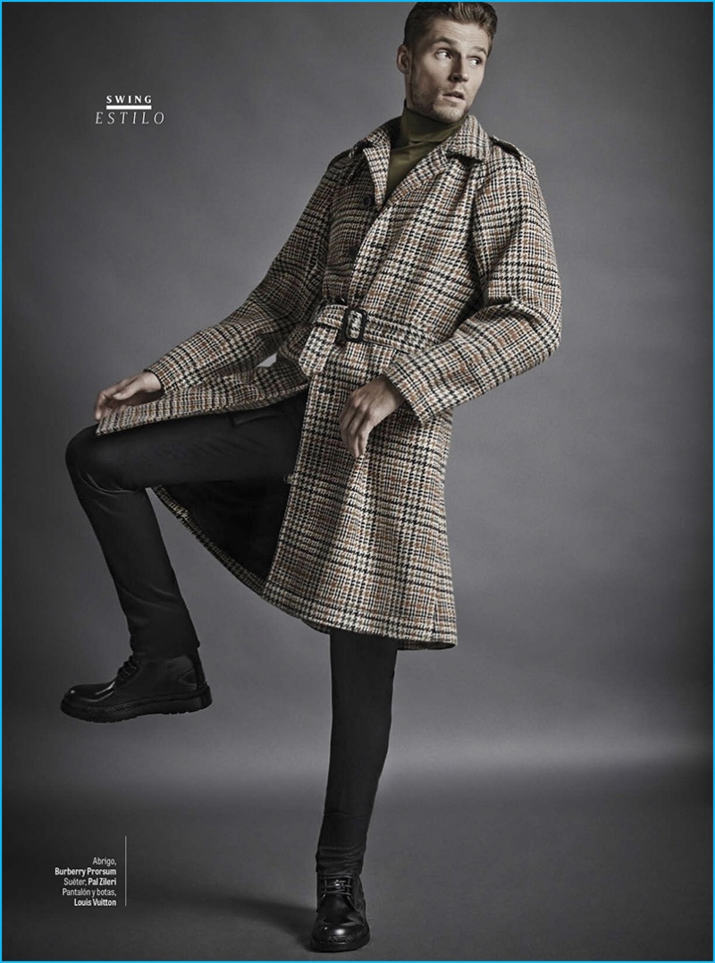 Pablo Valero photographs Mikus Lasmanis in a Burberry coat with a Pal Zileri sweater. Mikus also dons a trousers and leather combat boots by Louis Vuitton.