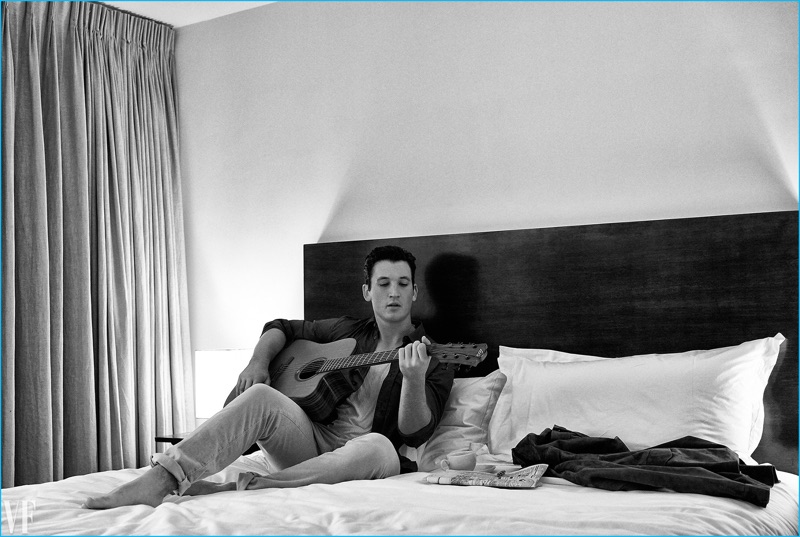 Playing the guitar, Miles Teller wears a Bottega Veneta shirt and Calvin Klein tank with Incotex trousers.