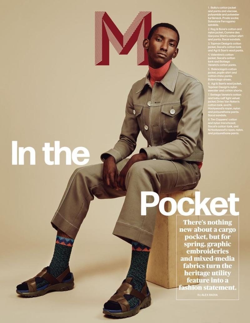 Myles Dominique sports a jacket, pants, and turtleneck by Bally. The model up and comer also wears Prada socks with Salvatore Ferragamo sandals.