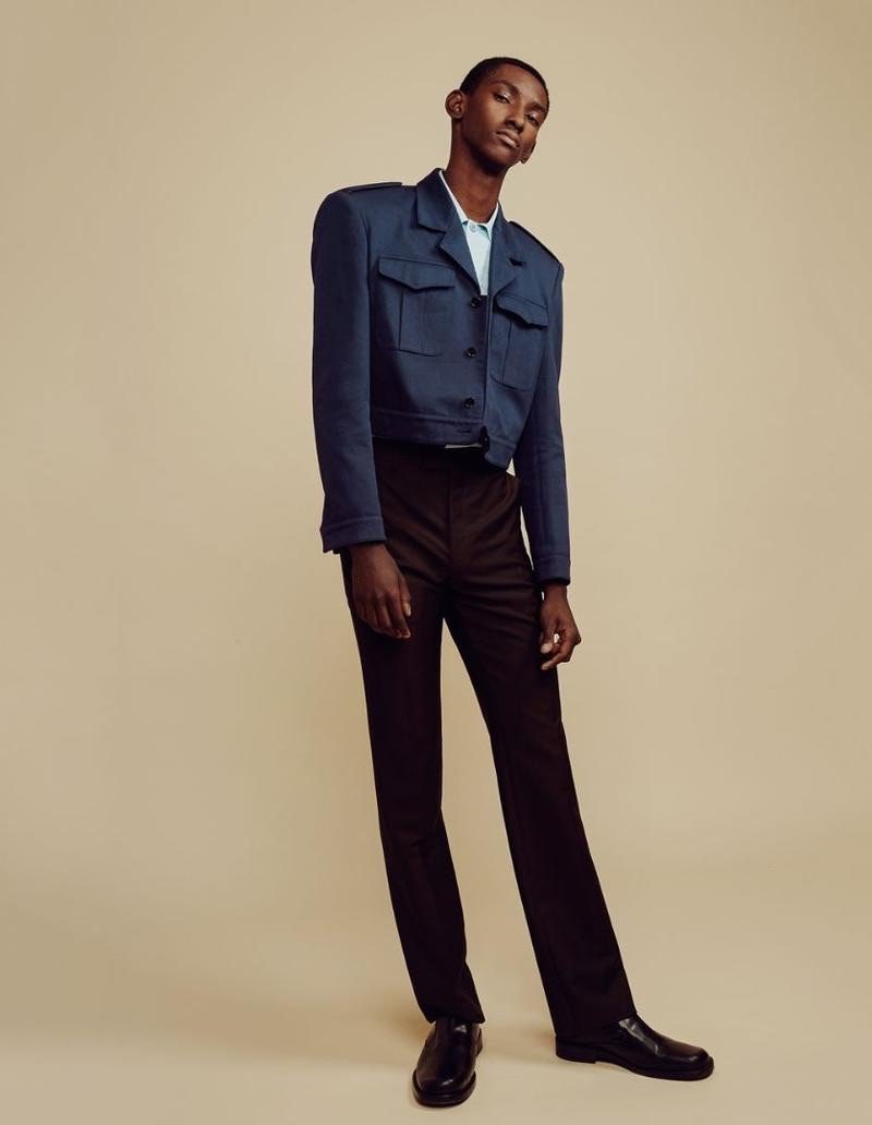 Going bold, Myles Dominique wears a Balenciaga military-style jacket, shirt, chinos, and shoes.