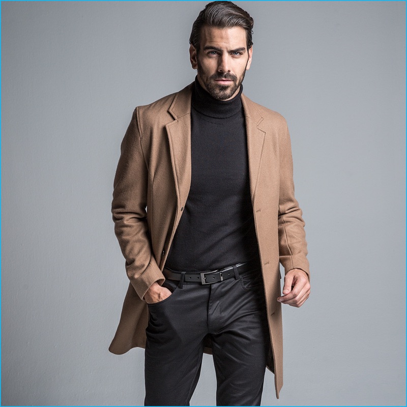 A sleek vision, Nyle DiMarco sports a single-breasted coat with a turtleneck  and trousers from INC International Concepts.