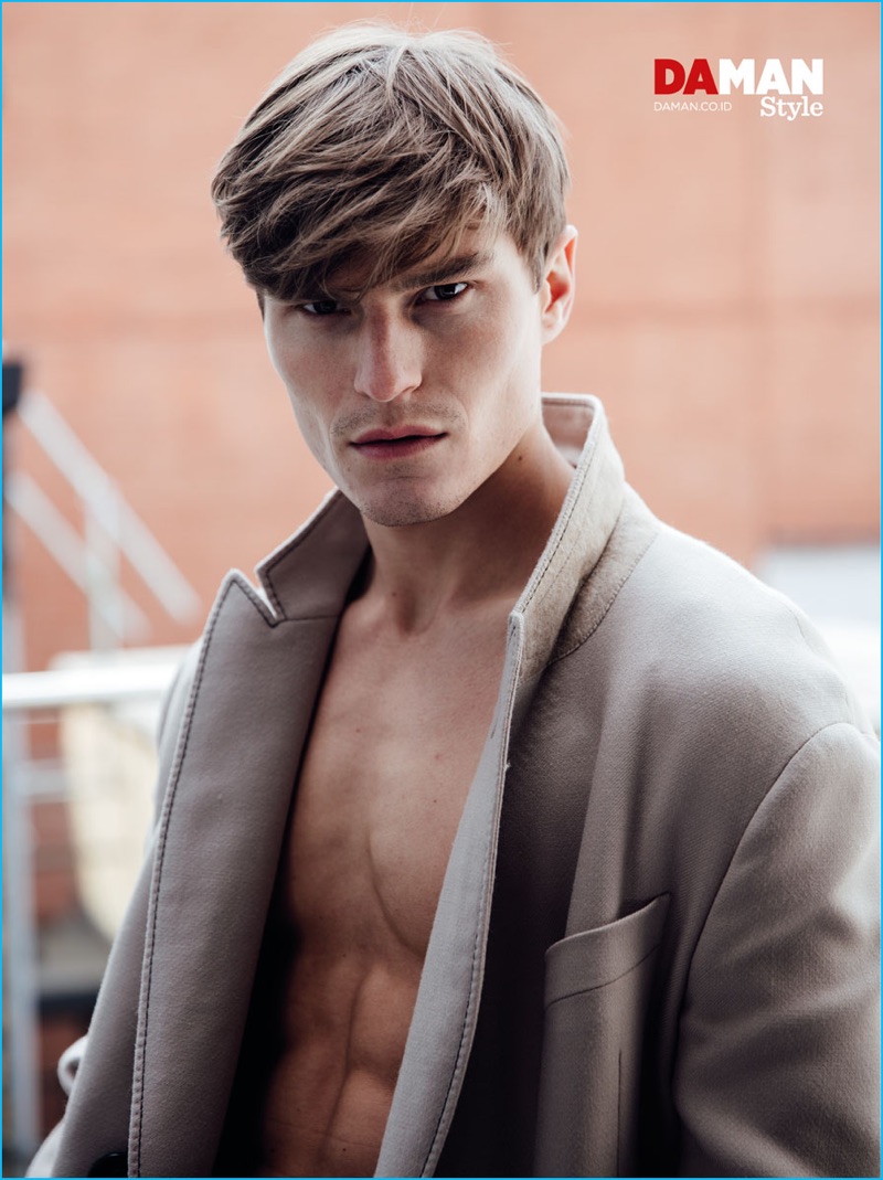 Appearing in a photo shoot for Da Man Style, Oliver Cheshire sports a Lanvin coat.