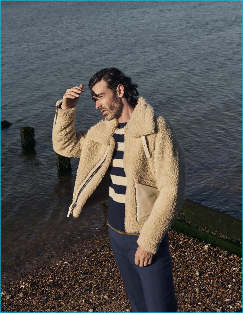 Embracing nautical style, Richard Biedul sports a shearling coat and striped sweater from Coach. The English model also dons Gucci trousers.
