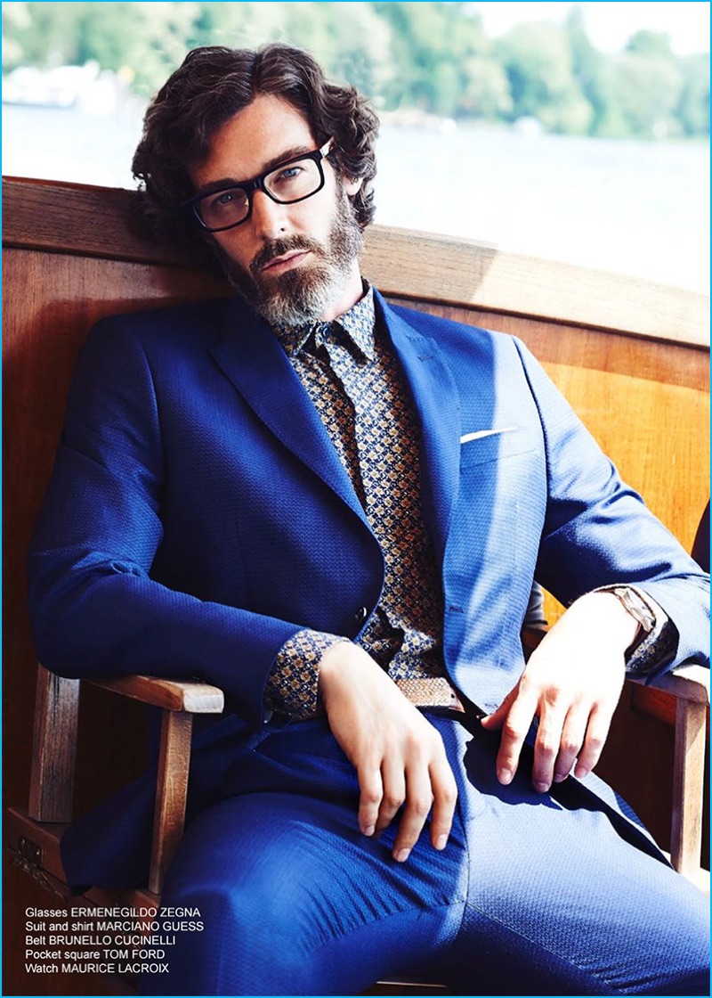 English model Richard Biedul dons Ermenegildo Zegna glasses with a shirt and suit from Marciano by GUESS. A Brunello Cucinelli belt, Tom Ford pocket square, and a Maurice Lacroix watch completes Richard's smart look.