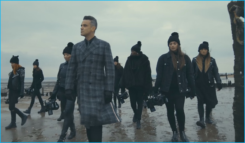 A still of Robbie Williams in his Love My Life music video. » Robbie Williams Rocks Thom Browne Plaid Coat for 'Love My Life' Music Video A still of Robbie Williams in his Love My Life music video.