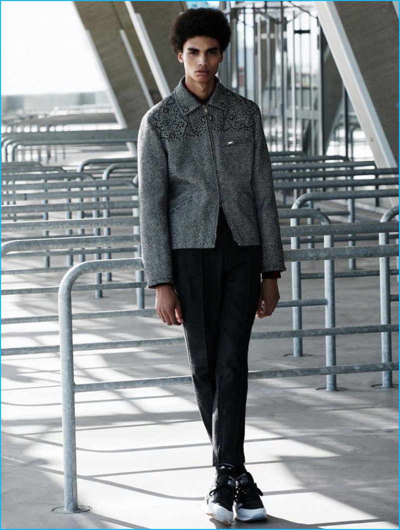 Tomas Falmer photographs Sol Goss in a tweed jacket from Valentino with a BOSS by Hugo Boss shirt, Dior Homme trousers, and Reebok sneakers.