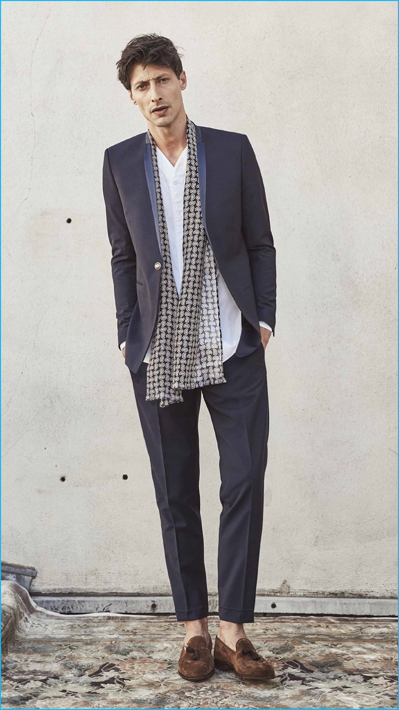 Appearing in The Kooples' spring-summer 2017 men's lookbook, Jonas Mason wears a one-button suit with a collarless shirt and scarf. » Travel the World with The Kooples' Spring 2017 Collection Appearing in The Kooples' spring-summer 2017 men's lookbook, Jonas Mason wears a one-button suit with a collarless shirt and scarf.