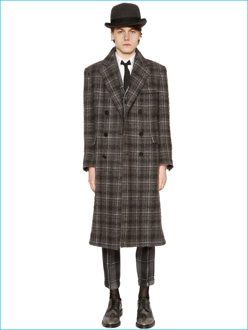 Thom Browne's plaid wool and mohair boucle coat styled with a hat and slim-cut trousers.